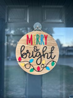 a merry and bright sign hanging on the front door