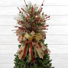 a christmas tree decorated with ribbons and bows