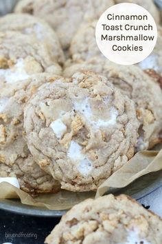 cookies with white frosting and crumbs sitting on top of each other in a metal pan