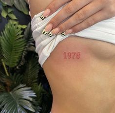 a woman's stomach with the number thirteen on it