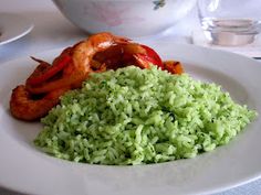 a white plate topped with rice and shrimp