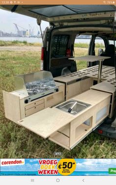 the back end of a van with an oven and sink in it