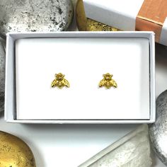 Solid Gold Bee Earrings, Silver Bee, Bee Studs, Bumble Bee, Bee Stud, Bumble Bee Stud Earrings, Nature Jewelry, Bee Lover, Tiny Studs WHAT IT IS AND WHY YOU WANT IT: Aren't these bumble bees adorable!? They are small and cute at about 9 mm wide. I start with fine silver or 22k solid gold metal. The piece is hand molded and then hand sanded to ensure a smooth shape, and then fired at 1650 degrees Fahrenheit. After the metal is fired, ear wires are soldered on using a blowtorch. Then the earrings Sterling Silver Earrings With Charms For Gifts, Sterling Silver Charm Earrings As Gift, Dainty Sterling Silver Charm Earrings, Yellow Gold Charm Earrings For Gift, Bumble Bee Jewelry, Bee Bee, Bee Studs, Earrings Nature, Bumble Bees