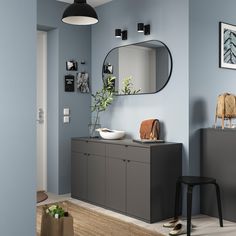 a room with blue walls and grey furniture