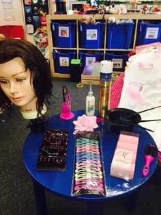 a mannequin's head sitting on top of a table next to other items