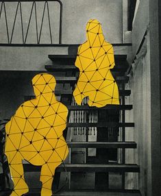 two people are sitting on the stairs in front of bookshelves with yellow geometric shapes