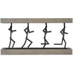 a metal sculpture with people dancing on it's sides