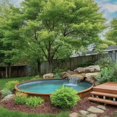 a backyard with a hot tub and steps leading up to the water feature in the back yard