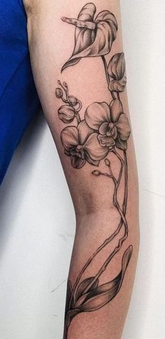 a black and white flower tattoo on the arm