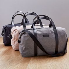 Part of our exclusive west elm Travel Collection, this lightweight, streamlined duffle bag is perfectly sized for short solo trips or weekends away. It has a removable shoulder strap and secures to our Hardside Spinner Luggage (sold separately) to make traveling in style easy. 27"w x 7.5"d x 15.75"h. Capacity: 50L. Nylon (Black) or polyester (Gray, Pale Pink) body. Bicast leather handles. Removable, adjustable shoulder strap. Large padded pocket for laptops or tablets. Zipper pocket. Perfect for Hardside Spinner Luggage, City Backpack, Weekend Bag, Duffle Bags, Holiday Magic, Duffel Bags, Travel Collection, Leather Travel, Retail Therapy