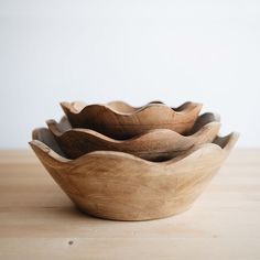 three wooden bowls sitting on top of a table