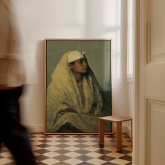 a man walking past a painting in a room with checkered floor and white walls