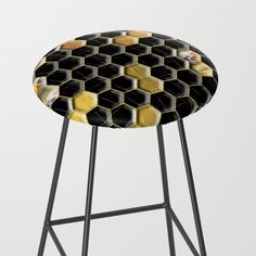 a black and yellow stool with hexagonal design