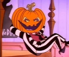 a cartoon character dressed as a jack - o'- lantern sitting on a chair