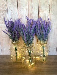 three mason jars with lavender flowers in them