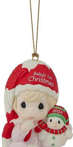 a baby's 1st christmas ornament with a snowman and santa hat