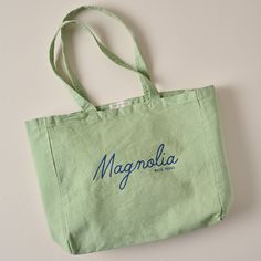 A catch-all for the things you collect throughout the day, this tote is ready to take on adventure with plenty of space to carry it all. Constructed with a soft, pigment-dyed fabric that only gets better with time, this souvenir bag is available in an array of colors and fonts. Vintage Green Canvas Bag For Travel, Rectangular Cotton Canvas Bag For Weekend Trips, Green Tote Shoulder Bag For Weekend Trips, Cotton Canvas Tote Bag For Weekend Trips, Rectangular Cotton Bag For Weekend Trips, Cotton Bags For Weekend Trips In Summer, Cotton Rectangular Bag For Weekend Trips, Cotton Bags For Weekend Trips During Summer, Vintage Canvas Gift Bag