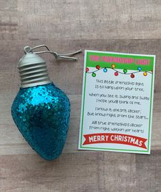 a christmas ornament is next to a card that says, the friendship light