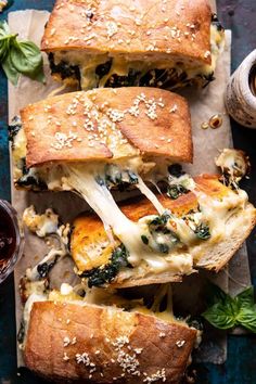 several sub sandwiches with cheese and spinach