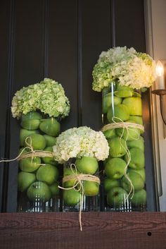 green apples and hydrangeas in mason jars tied with twine on the ledge