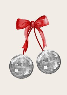 two disco ball ornaments tied with a red ribbon