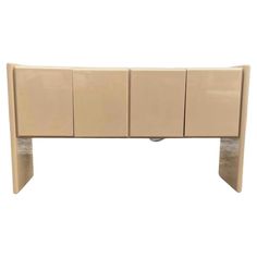 a beige headboard with four doors and three drawers on each side, against a white background