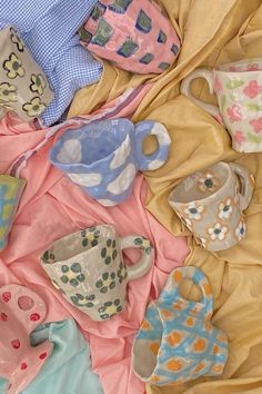 various tea cups and saucers on a blanket