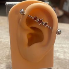 an ear with three stars attached to it