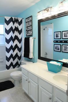 a bathroom with blue walls and black and white decor