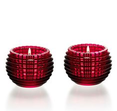 two red candles sitting next to each other