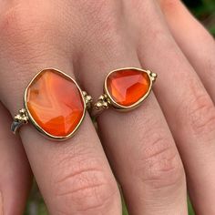 The incredible texture in this striped Rosecut Carnelian is truly one of a kind. Like a flowing river of orange lava it is set in 14k yellow gold with accent beads and a freeform sterling silver band. Approximate stone size: 14mm x 17mm 5.8 cts Mohs Stone Hardness: 6 This one of a kind piece is handmade to in Emily's Hudson Valley studio. This piece is in stock and can be resized prior to shipping. If you have questions about sizing, shipping or need help deciding please reach out to us! Flowing River, Orange Gem, Orange Stone, Local Jewelry, Gems Jewelry, Sterling Silver Bands, Hudson Valley, Cocktail Ring, Piercing Jewelry