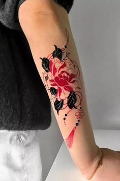 a woman with a flower tattoo on her arm