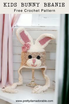 a crocheted bunny beanie sitting on top of a shelf next to a window