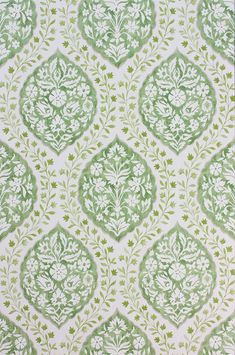 a green and white wallpaper with an ornate design on it's surface,