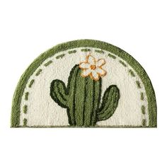 a green and white rug with a cactus on it's side, in the shape of a circle