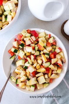 a white bowl filled with chopped vegetables next to another bowl full of diced vegetables