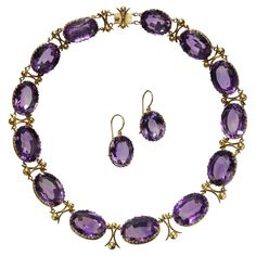 An antique amethyst and gold riviére necklace and earrings suite, with large, oval faceted, graduated amethysts, in open backed decorative, trefoil design, gallery strip bezel settings, with curved cross and ball links between the amethysts, with a gold box and tongue clasp, with matching drop earrings, on gold wires, circa 1880. Estimated total weight of amethysts in the necklace 259.99 carats and in the earrings 28.22 carats. Some of the earliest examples of amethyst jewellery are seen in work Amethyst Rock, Moonstone Drop Earrings, Amethyst Set, Diamond Cluster Earrings, Amethyst Gold, Gold Box, Amethyst Jewelry, White Gold Earrings, Victorian Jewelry