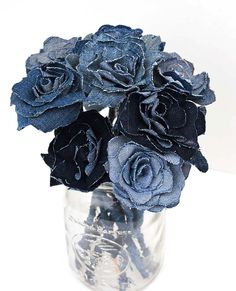 a vase filled with blue flowers on top of a table