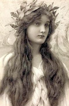 a woman with long hair wearing a wreath on her head and the words beauty is objective