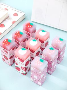 six strawberry shaped boxes are sitting on the table