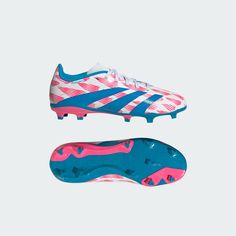 a pair of soccer shoes with pink and blue stripes on the soles, against a white background