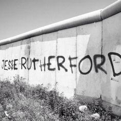 black and white photograph of graffiti on the side of a wall that reads jese ruttener ford