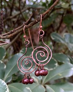 Hammered Copper Circles with Burgundy Pearl Dangles. Lightweight, flirty earrings.Approximately 1 1/2" long and 5/8" wide.These earrings have been antiqued, polished and sealed.Sealed with Protectaclear ProtectaClear is a clear, protective coating that is tough enough to protect jewelry and is safe for wear against skin. ProtectaClear is practically invisible once applied and will seal and protect jewelry from tarnish, oxidation, and corrosion Pierced Copper Dangle Earrings, Copper Chandelier Dangle Earrings For Pierced Ears, Drilling Glass, Hammered Copper Earrings, Wire Wrap Jewelry Designs, Pearls Earrings, Earring Designs, Wrap Jewelry, Hammered Copper