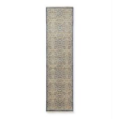 a beige and blue runner rug with an intricate design on the bottom, in front of a white background