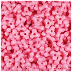 pink beads with holes in the middle are shown from above, and on top of each other