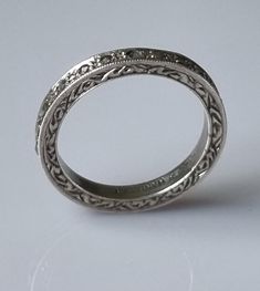 Quite the prettiest ring from the early 1900s. Sterling silver band with a width of 2.5mm, and set with marcasites inset along the length of the ring. The sides of the ring are engraved with a scroll design, giving it the attention at all angles - sideways and face on. Weight is 2.7g Ring size: US: 6  UK: L 1/2 Antique Engraved Ring With Decorative Band, Victorian Engraved Ring With Decorative Band For Anniversary, Antique Engraved Ring With Decorative Band For Anniversary, Antique Engraved Ring Hallmarked, Antique Engraved Round Band Ring, Silver Stackable Rings With Rose Cut Diamonds, Antique Silver Ring With Decorative Band, Victorian Engraved Diamond Wedding Ring, Antique Silver Rings With Decorative Band