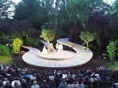 an aerial view of a stage with people sitting on it