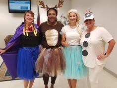 four women dressed up in costumes posing for the camera