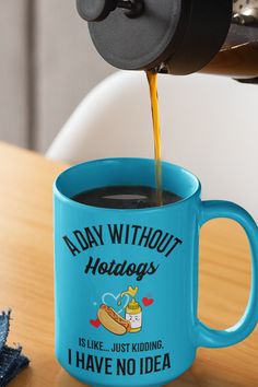 coffee being poured into a blue mug on top of a wooden table with the words today without hotdogs