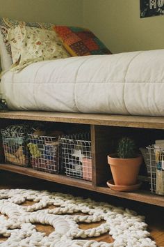 a bed sitting on top of a wooden shelf